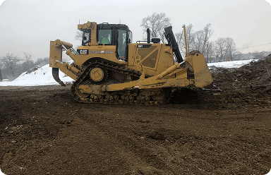 Construction machine pushing dirt